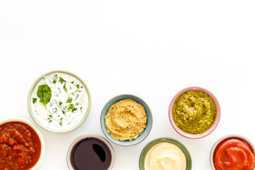 Set of sauces in bowls - pesto salsa mustard and others. Food background - 779670939