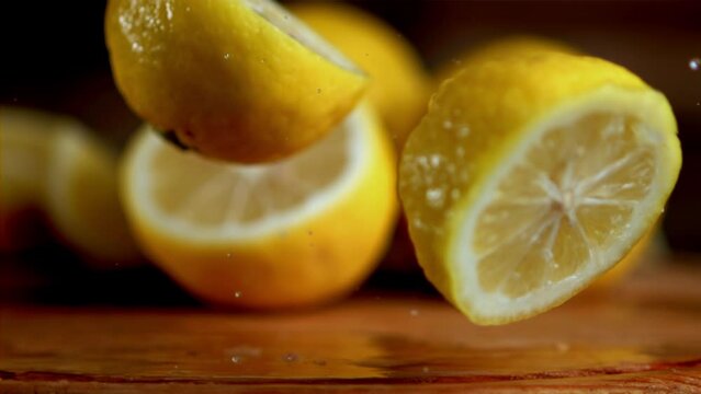 A group of citrus fruits, lemons, are displayed on a wooden table. Lemons are a staple food ingredient often used in recipes to add a tangy flavor to dishes