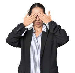 Confident young Caucasian businesswoman on studio background afraid covering eyes with hands.