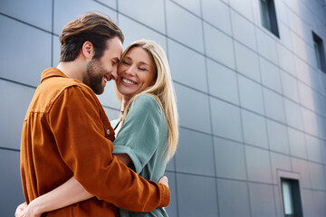 A sensual moment between a man and woman, wrapped in each others arms in front of a striking...