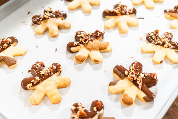Obraz na płótnie Canvas Snowflake-Shaped Sugar Cookies, Chocolate-Dipped, Pecan Crushed Nuts, Holiday Baking