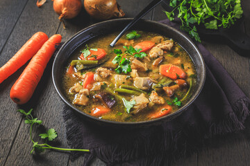 Homemade meat and vegetable stew or soup with mushrooms