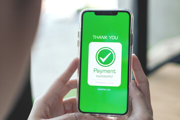 Online financial transactions and payment successful. Close-up of hand using smartphone for payment of shopping transaction By credit card online banking