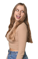 Fototapeta premium Studio portrait of a blonde Caucasian woman looks aside smiling, cheerful and pleasant.