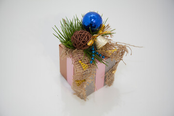 Christmas beautiful gift wrapping. Fir cones and needles. Tied with a satin ribbon. blue ball. On a...