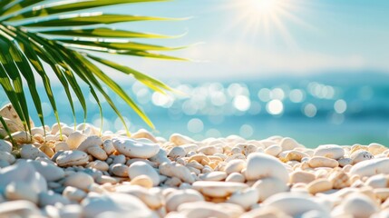 Fototapeta na wymiar Sunny beach scenery with smooth pebbles and palm leaves foreground, glistening sea backdrop.