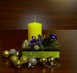 Christmas composition . Beautiful gift wrapping. Yellow Candle. Fir cones and needles. New year's...