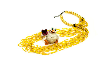 Concept of female jewelry. yellow women's necklace. White dove. Jewelry Set. on an isolated white...