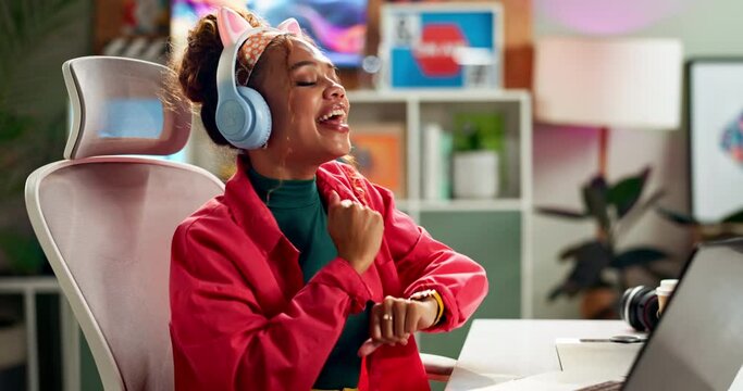 Work, laptop and headphones dancing from music break in office of a graphic designer with web audio. Entrepreneur, success and celebration with internet radio streaming at a digital company desk