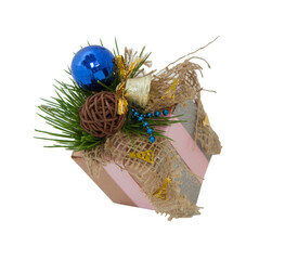 Christmas beautiful gift wrapping. Fir cones and needles. Tied with a satin ribbon. blue ball. On a white isolated background	