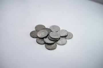 Five hundred IDR metal coins are collected on a table with a white background