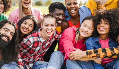 Young diverse people having fun outdoor hugging each others - Diversity, support and LGBT community concept - Main focus on bald girl face