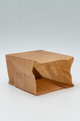 Brown paper bag on white background - 779697756