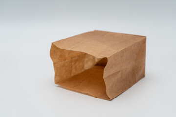 Brown paper bag on white background - 779697780