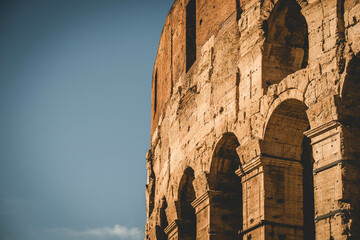 Detailed close-up of Roman Colosseum under a blue sky