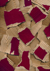 Texture from pieces of torn colored cardboard. Red brown carton background. Recycling concept. Rough pieces of ripped corrugated ribbed green cardboard made from recycled materials. Design element