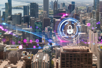 Aerial view of Chicago cityscape with a hologram of a security padlock and digital elements overlaying the downtown area. Double exposure