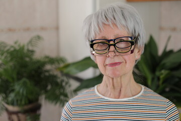 Senior woman wearing three eyeglasses simultaneously