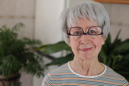 Senior woman wearing her eyeglasses upside down 