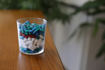Glass with lots of different pills