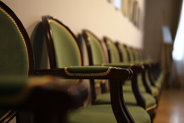 a row with wooden chairs in the auditorium