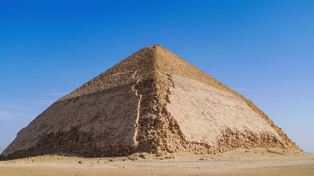 The Bent Pyramid is an ancient Egyptian pyramid located at the royal necropolis of Dahshur, approximately 40 kilometres south of Cairo, built under the Old Kingdom Pharaoh Sneferu. Egypt