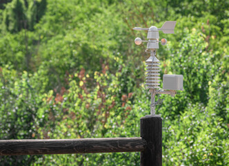 Weather vane marking the direction of the wind and anemometer (wind speed meter) blurred by the...