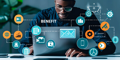 Professional using laptop to access benefits & employee services dashboard, icons representing human resources, insurance, payroll, retirement plans & corporate benefit programs offered to workers