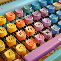 The old-fashioned typewriter keyboard produces lovely letters in rainbow colors. Creative poetry or...