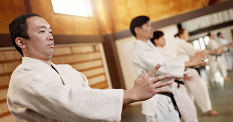 Obraz premium Aikido class, group and fight for martial arts, strike or together for combat at training, gym or dojo. Japanese people, students or sensei for exercise, workout or fitness with zen, conflict or club