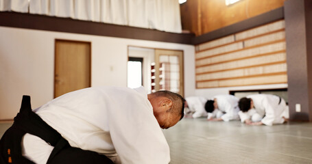 Aikido, students and bow to master in dojo for martial arts practice, discipline or class in self...