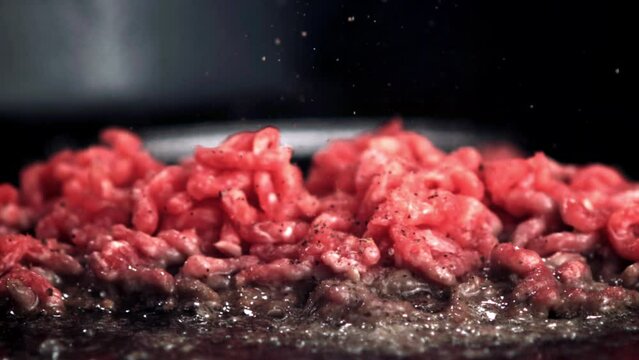 Ground beef, an animal product, is being cooked in a pan as part of a recipe. The cuisine being prepared is a savory dish using this natural ingredient