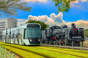 The electric light rail overtaking the steam locomotive symbolizes the evolution of the times and the progress of science. Hamasen Railway Cultural Park,Kaohsiung City,Taiwan.For branding, screensave.