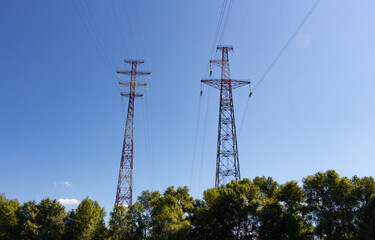 Anchor high-voltage poles on the background of the blue sky
