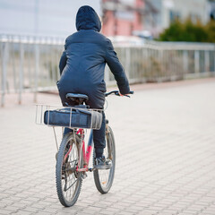Pizza delivery service, man delivering pizza by bicycle. Fast and efficient urban pizza delivery, man delivers pizza by bicycle, ensuring hot and fresh meals to doorstep. Selective focus