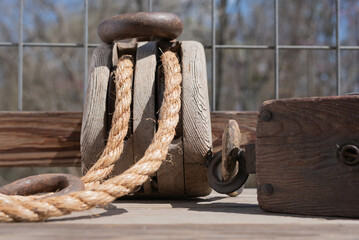 Two sizes of Antique block and tackle with jute rope.