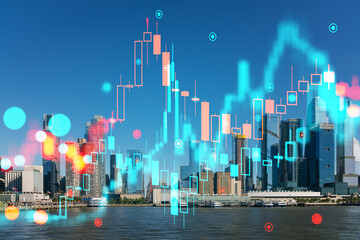 New York skyline with holographic stock market charts superimposed. Double exposure