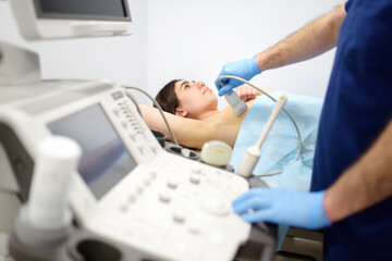 Mammologist doctor examines a woman breasts and lymph nodes using ultrasound. Mammography and...