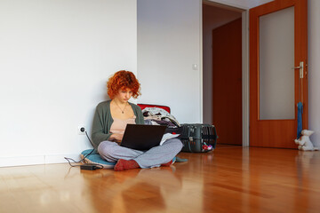 portrait red-haired teenage girl, student, studying online at home