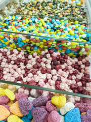 A variety of candy in a display case. Jelly sugar candies. Colorful Sweets on a market, candy shop.
