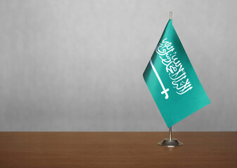 Saudi Arabia table flag on gray blurred background