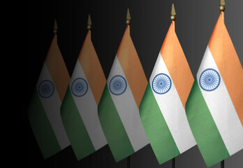 Row of Indian flags on a dark background in perspective