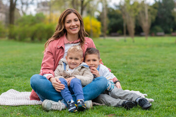  Portrait of mother and kids sitting in the park