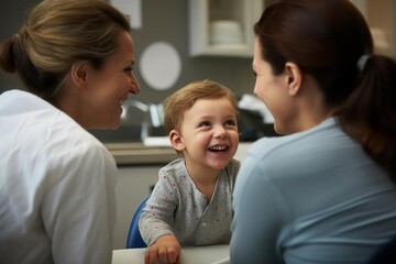 Smiling child talking to mom and doctor in examination room