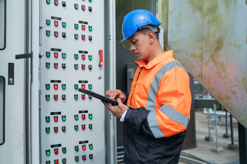 Technician Operating Control Panel in Industrial Setting