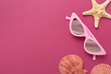 Stylish pink sunglasses on color background, top view. Summer concept
