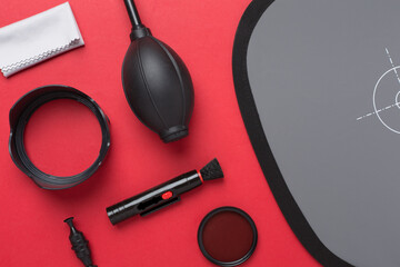 Different camera equipment and products on color background, top view