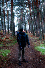 Naklejka premium Man standing in snowy landscape, promoting rural tourism and environmental conservation.