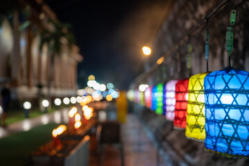 Colorful lanterns at night at a traditional Thai temple, lights in evening on blurred background.
