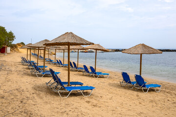Sun loungers on sandy Limnionas beach. Kos island, Dodecanese, Greece
